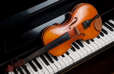 violin setting on top of piano keys